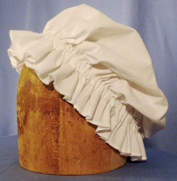 Mob Cap by White Pavilion Costumes, side view. This cap is perfect for living history reenactors in all eras from the medieval through the renaissance, 17th and 18th centuries, and into Victorian times. It's also a perfect accent for fantasy and fairytale costumes.