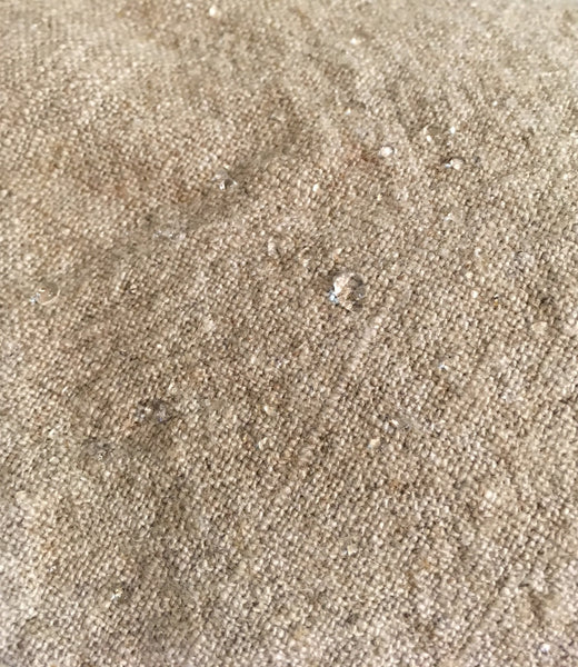 Greatcoat linen/rayon fabric, closeup, with water beading on surface to demonstrate water resistance